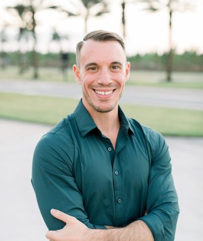 a man in a green shirt is posing for a picture
